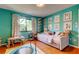 Bright bedroom featuring wood floors, a bed, wall art, window, table and chairs, and a mini trampoline at 604 Knollwood Dr, Largo, FL 33770