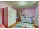 bedroom featuring a wardrobe, bed, stylish curtains, and colourful rug at 604 Knollwood Dr, Largo, FL 33770
