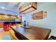 Open concept kitchen with adjacent dining room, features pendant lighting, stainless steel appliances, and custom wood cabinetry at 604 Knollwood Dr, Largo, FL 33770