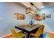 Dining room features natural light, pendant lighting, a large table with yellow chairs, and Gathering photos on the wall at 604 Knollwood Dr, Largo, FL 33770
