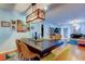 Modern dining room features a wooden table, stylish yellow chairs, and contemporary lighting fixture at 604 Knollwood Dr, Largo, FL 33770
