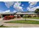 Beautiful single-story home with mature landscaping and a circular driveway at 604 Knollwood Dr, Largo, FL 33770