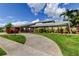 Inviting home with lush greenery, a lamp post, and a circular concrete driveway at 604 Knollwood Dr, Largo, FL 33770