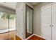Hallway with an elegant mirror on the wall and a door leading to the outside at 604 Knollwood Dr, Largo, FL 33770