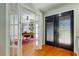Bright home office showcasing french doors and luxury vinyl plank flooring at 604 Knollwood Dr, Largo, FL 33770