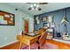 Stylish home office featuring guitars, wood floors, and ample natural light at 604 Knollwood Dr, Largo, FL 33770
