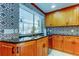 Spacious kitchen area with a stainless steel dishwasher, stainless steel sink, brass faucet, and a decorative backsplash at 604 Knollwood Dr, Largo, FL 33770