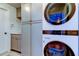Modern laundry room featuring a stacked washer and dryer with built-in cabinetry at 604 Knollwood Dr, Largo, FL 33770