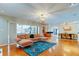 Spacious living room showcases hardwood floors, modern furnishings, and an open layout to the dining area at 604 Knollwood Dr, Largo, FL 33770