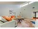Bright living room features a comfortable sectional sofa and access to a screened in lanai at 604 Knollwood Dr, Largo, FL 33770