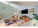Modern living room with high ceilings, a large TV, and comfortable seating at 604 Knollwood Dr, Largo, FL 33770