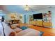 Open concept living room shows hardwood floors, modern furnishings, and access to the dining room at 604 Knollwood Dr, Largo, FL 33770