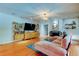 Bright living room boasts hardwood floors, modern furniture, and a cozy fireplace at 604 Knollwood Dr, Largo, FL 33770