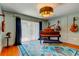 Stylish music room featuring an upright piano, hardwood floors, and custom paint at 604 Knollwood Dr, Largo, FL 33770