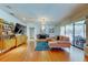 Open living room with hardwood floors, stylish furniture, and sliding doors leading to outdoor patio at 604 Knollwood Dr, Largo, FL 33770