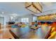 Open concept living space features a dining room, kitchen with bar seating, fireplace, and a pink sofa at 604 Knollwood Dr, Largo, FL 33770