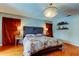 Cozy main bedroom boasts hardwood floors, a decorative chandelier, and stylish bedside lighting at 604 Knollwood Dr, Largo, FL 33770