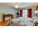 Main bedroom showcases hardwood floors, a chandelier, and sliding doors opening to the backyard at 604 Knollwood Dr, Largo, FL 33770