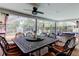 Spacious outdoor dining area with a view of the pool, featuring comfortable seating and a relaxing atmosphere for gatherings at 604 Knollwood Dr, Largo, FL 33770