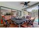 Elegant outdoor dining area with seating for six, featuring a view of the pool and an open connection to the living room at 604 Knollwood Dr, Largo, FL 33770