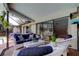 Cozy outdoor living area featuring a comfortable blue sofa and white wicker chairs, perfect for relaxing and enjoying the view at 604 Knollwood Dr, Largo, FL 33770
