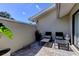 A cozy brick-paved patio with comfortable chaise lounges and lush greenery, perfect for relaxation and outdoor living at 604 Knollwood Dr, Largo, FL 33770