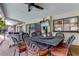 Charming outdoor seating area with a large dining table, offering a great view of the living room and backyard at 604 Knollwood Dr, Largo, FL 33770