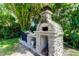 Outdoor pizza oven and built-in grilling area, perfect for backyard entertaining at 604 Knollwood Dr, Largo, FL 33770
