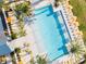 Aerial view of community pool surrounded by palm trees, umbrellas, and lounge chairs at 6057 Marsh Trail Dr, Odessa, FL 33556