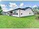 Home's exterior has covered porch overlooking fenced-in backyard, ready for entertaining at 6057 Marsh Trail Dr, Odessa, FL 33556