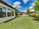 Well-manicured lawn in backyard shows home's exterior and landscaping at 6057 Marsh Trail Dr, Odessa, FL 33556