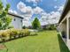 Fenced-in backyard features lawn and landscaping, with a tranquil pond in the distance at 6057 Marsh Trail Dr, Odessa, FL 33556