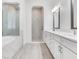 Luxurious bathroom with dual vanities, a soaking tub, and a walk-in shower at 6057 Marsh Trail Dr, Odessa, FL 33556