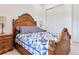 Cozy bedroom featuring a wooden bedframe and a blue and white quilt at 6057 Marsh Trail Dr, Odessa, FL 33556