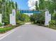 Community entrance with 'TARRAMOR' sign surrounded by lush trees and plants at 6057 Marsh Trail Dr, Odessa, FL 33556