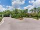 Gated community entrance with lush landscaping and a picturesque view at 6057 Marsh Trail Dr, Odessa, FL 33556