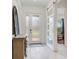 Well-lit entryway showcasing a sliding door, white trim, wood floors and a decorative accent piece at 6057 Marsh Trail Dr, Odessa, FL 33556