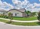 Beautiful home features stone accents, manicured lawn, and tasteful landscaping at 6057 Marsh Trail Dr, Odessa, FL 33556