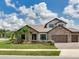 Stunning two-story home features a three-car garage and landscaped front yard at 6057 Marsh Trail Dr, Odessa, FL 33556
