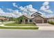 Attractive stone home featuring a lush lawn, palm trees and a paved driveway at 6057 Marsh Trail Dr, Odessa, FL 33556