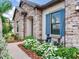 Close-up of home with beautiful stone accents, lush landscaping and a charming fountain at 6057 Marsh Trail Dr, Odessa, FL 33556