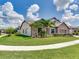 Landscaped home with stone accents, lush lawn and a well-maintained sidewalk at 6057 Marsh Trail Dr, Odessa, FL 33556