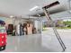 Spacious three-car garage with epoxy floor and attic access for ample storage at 6057 Marsh Trail Dr, Odessa, FL 33556