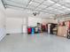 Spacious two car garage with sealed flooring, and overhead storage rack at 6057 Marsh Trail Dr, Odessa, FL 33556