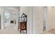 Open hallway design featuring light wood laminate floors, an antique dresser, and white accents at 6057 Marsh Trail Dr, Odessa, FL 33556