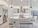 Modern kitchen showcasing an island with bar seating, stainless steel appliances, and white cabinets with pendant lighting at 6057 Marsh Trail Dr, Odessa, FL 33556