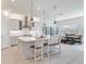 Bright kitchen featuring an island with pendant lighting and seating, stainless steel appliances, and an adjacent dining area at 6057 Marsh Trail Dr, Odessa, FL 33556