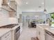 Bright kitchen with stainless steel appliances and white subway tile backsplash open to dining area at 6057 Marsh Trail Dr, Odessa, FL 33556