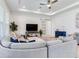 Bright living room featuring a ceiling fan, recessed lighting, and sliding door, perfect for relaxation and entertainment at 6057 Marsh Trail Dr, Odessa, FL 33556