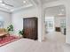 Inviting living room featuring light tile floors, neutral walls, and an elegant armoire adjacent to the dining area at 6057 Marsh Trail Dr, Odessa, FL 33556